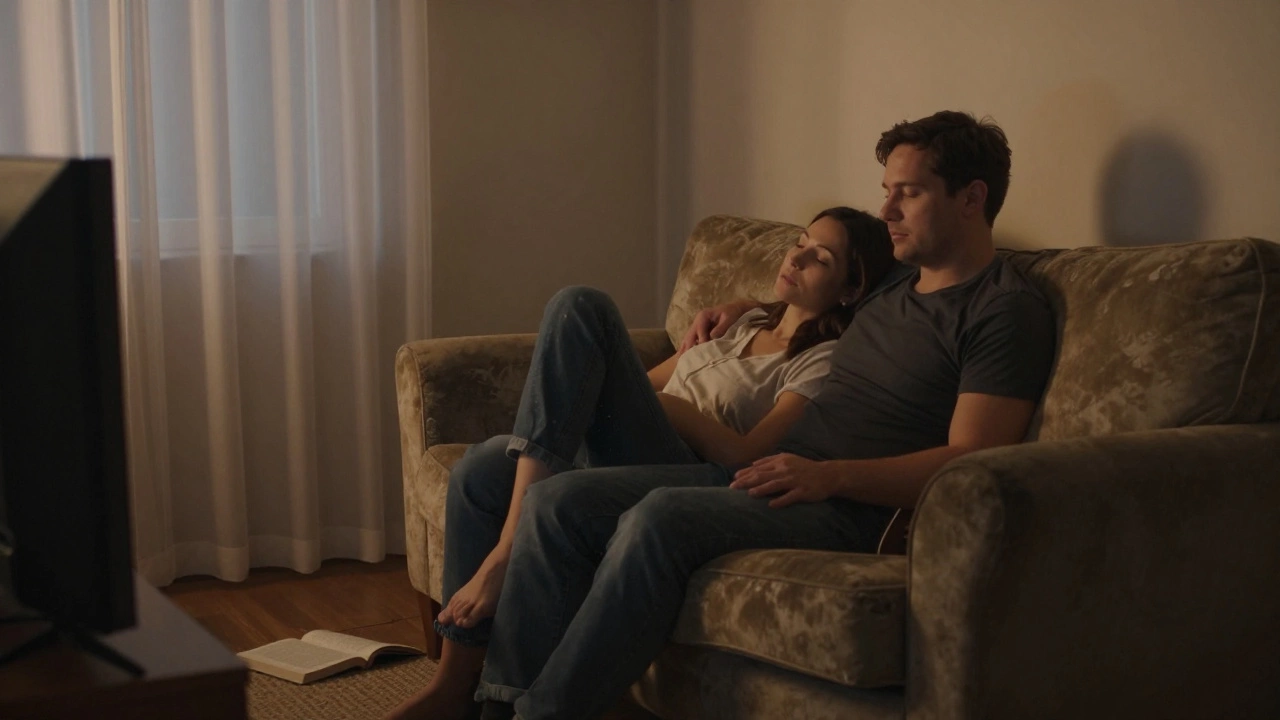 Two people cuddling on a couch at dusk, relaxed and silent, sharing a peaceful moment.