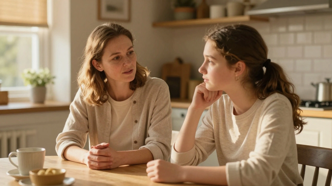 Mother listening supportively to teen at kitchen table